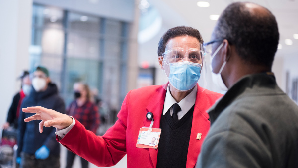 Cleveland Clinic red coat assisting patient