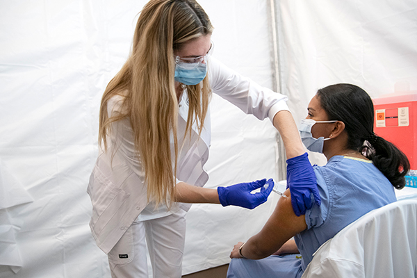 Cleveland Clinic nurse receiving the Pfizer COVID-19 vaccine