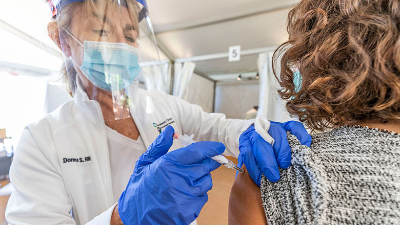 Cleveland Clinic nurse administering the Pfizer COVID-19 vaccine