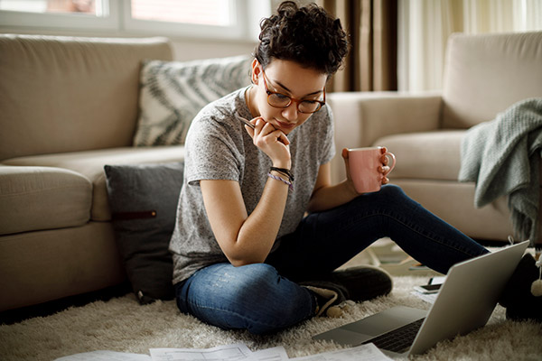 Student looking at financial aid information and computer