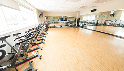 Fitness room filled with exercise bikes and other gym equipment