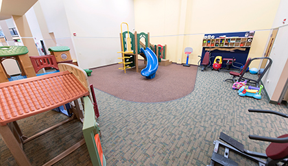 Kids playroom with toys, slide, basketball hoop and more