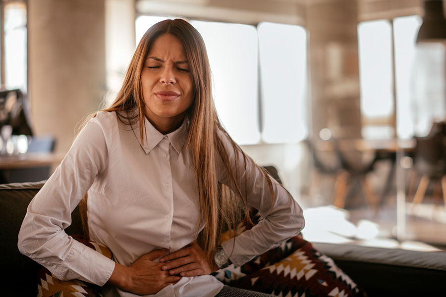 Person clutching stomach in pain