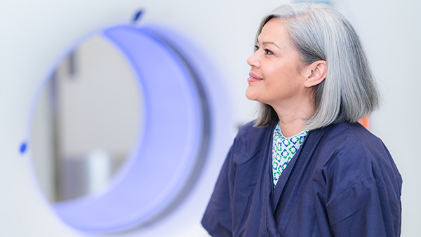 Patient with a CT machine in the background.