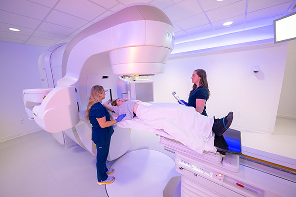 A patient speaking to Cleveland Clinic Caregivers in a RadOnc machine.