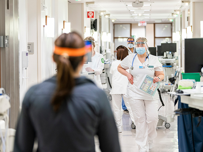 Cleveland Clinic nurses walking down a busy hospital wing
