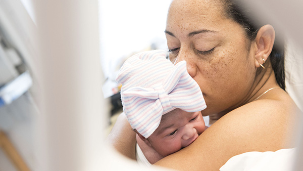 Woman holding newborn baby