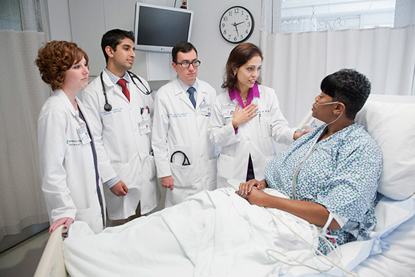 Cleveland Clinic caregivers practicing the R.E.D.E. to Round method during rounds with a patient
