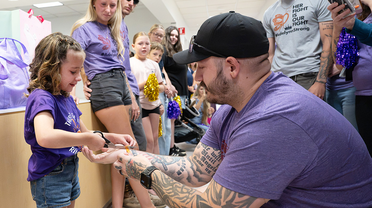 Adelynn cutting bracelet off her dad