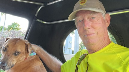 John with his dog Curry in a golf cart