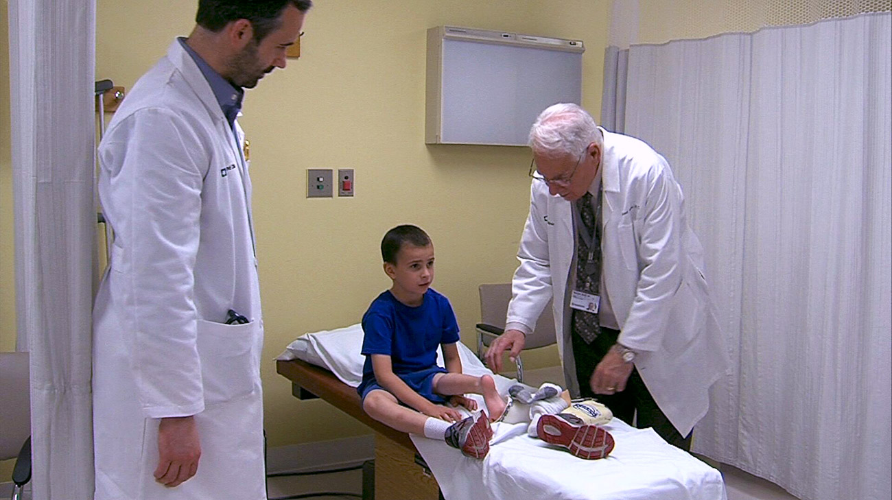  Dr. Joyce examines Liam’s leg before putting on the prosthetic.