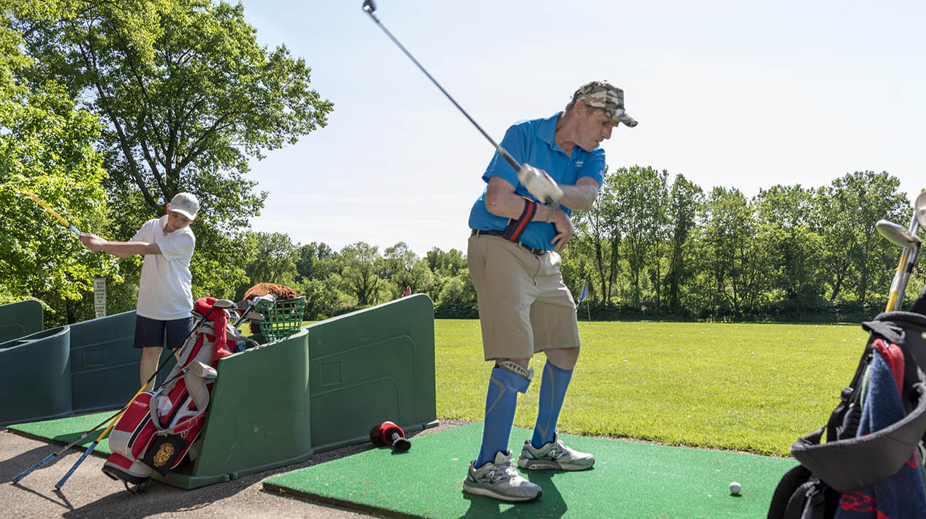 Vietnam veteran Charlie Morris golfs with his son and grandson at Challenge Golf. 