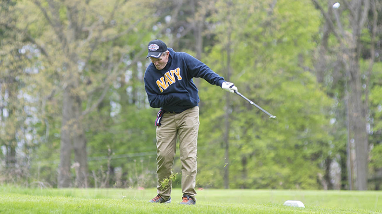 Vietnam veteran Charlie Morris golfs with his son and grandson at Challenge Golf. 