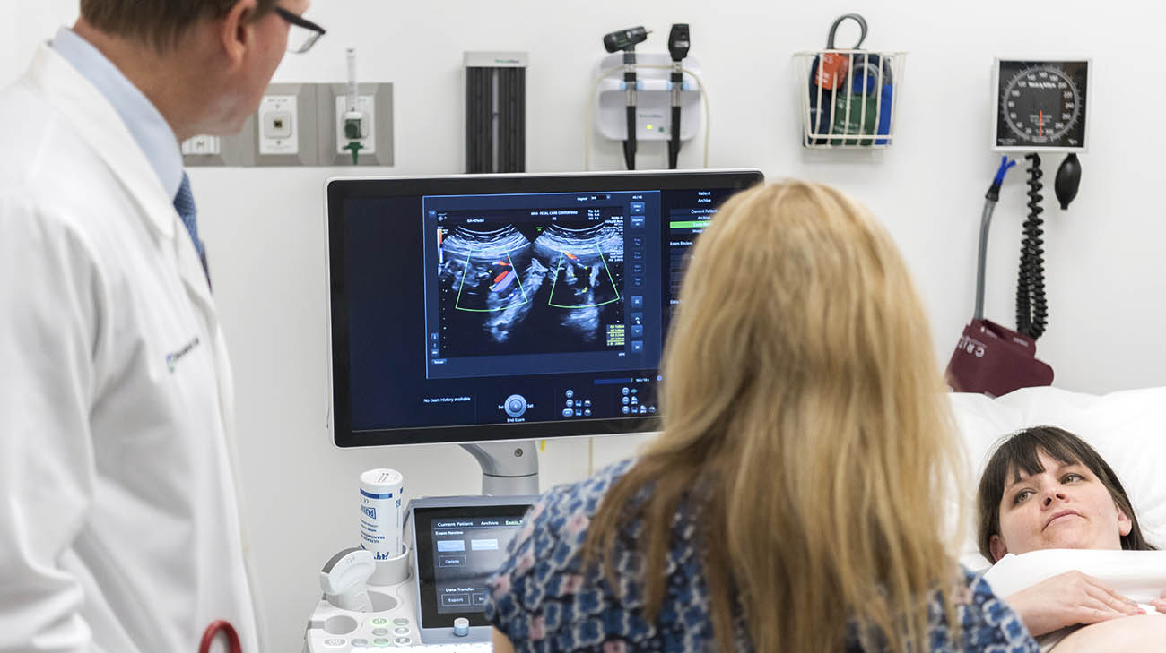 Dr. Darrell Cass and Dr. Amanda Kalan peforming an ultrasound on Kimmie McCaw. 