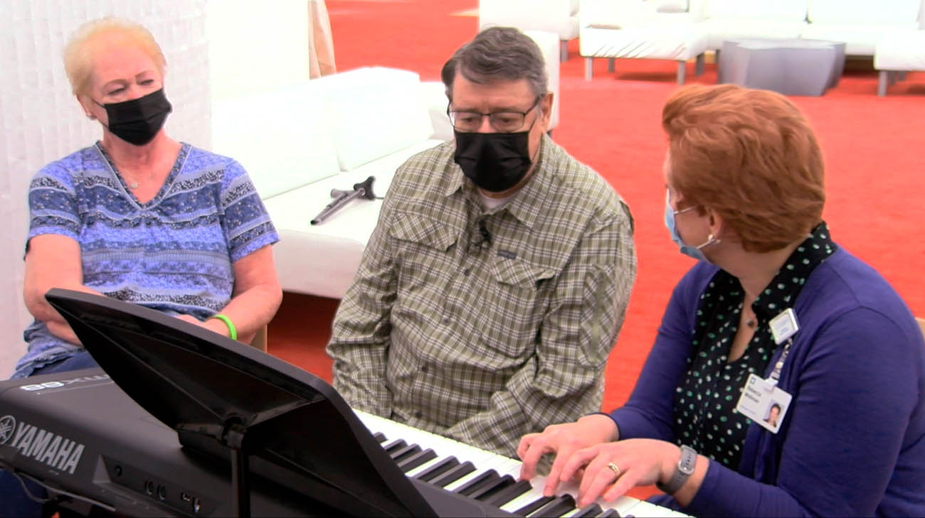 Jim gifting a song to his wife, Linda, during music therapy. 