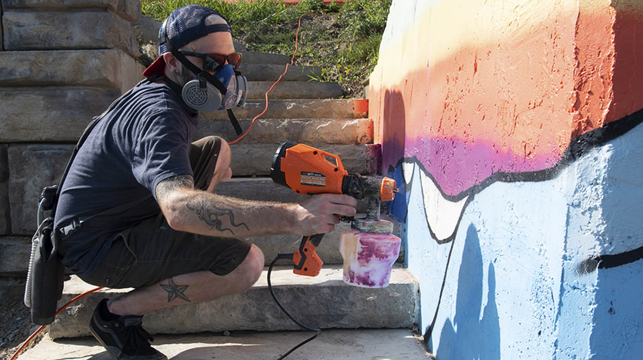 Jon Sedor creating a mural at Edgewater in Cleveland, Ohio. 