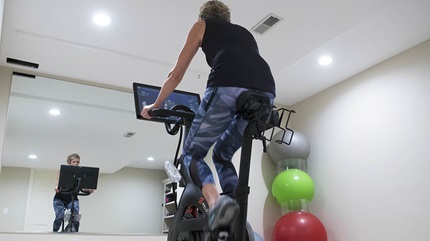 Sally riding her stationary bike at home. 