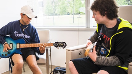 Teen cancer patients, Aidan Comer and Marco Kaiser play guitar at Cleveland Clinic Children's. 