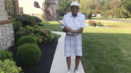Harold Brown practicing his swing after knee replacement surgery