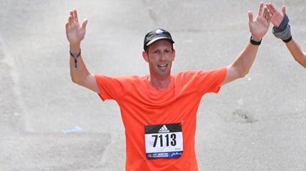 Brad crossing the finish line at the Boston Marathon. 