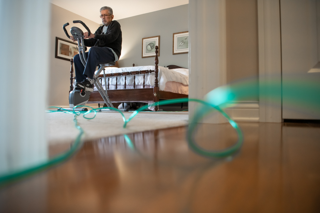 Manmohan Sachdeva on an exercise bike, hooked up to oxygen.