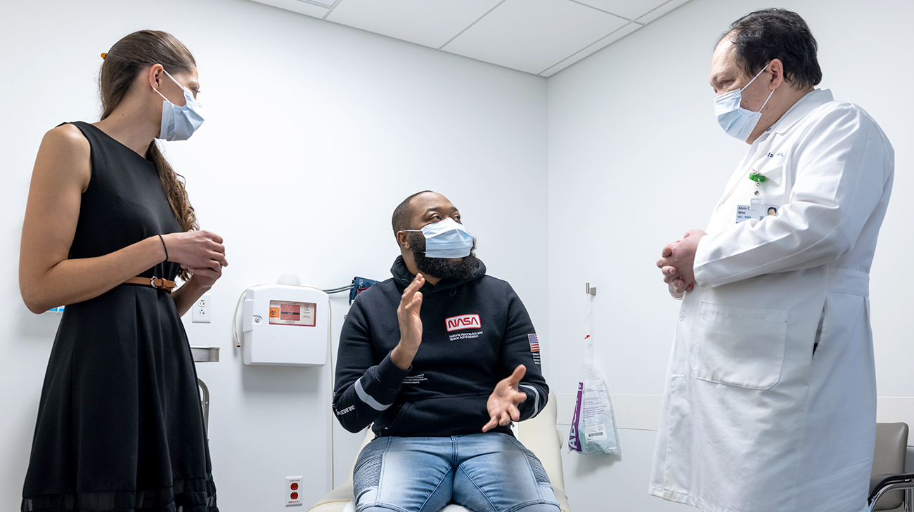 Patient Robert Terry with Dr. Anita Modi and Dr. Alvin Wee at a follow-up appointment