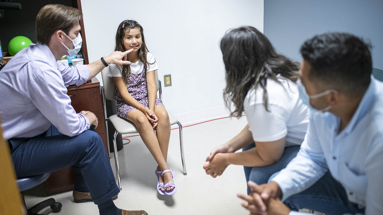 Nicole and her parents during a therapy session with Cleveland Clinic physical therapist Mike Harrington. 