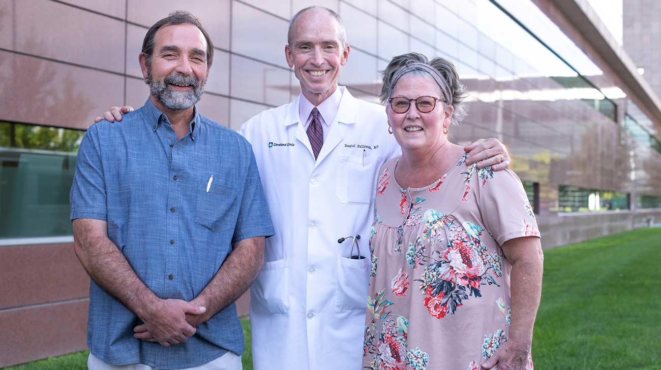 Daniel Sullivan, MD standing with Traci and Don Hiltz.