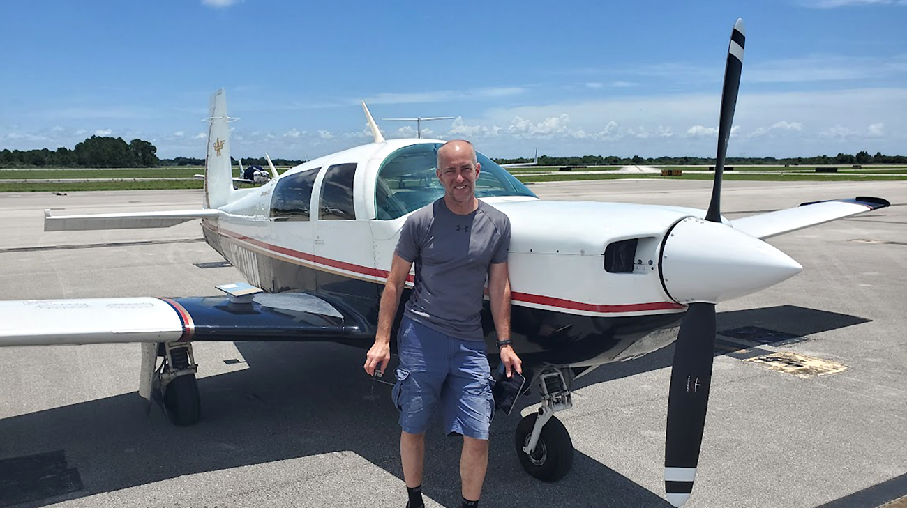 Dan Luciano posing in front of his airplane.