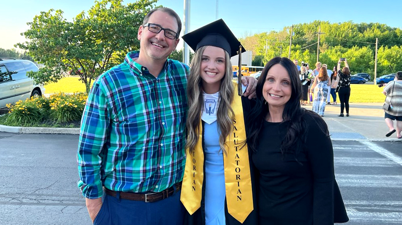 Abby with her mom and dad at her high school graduation.
