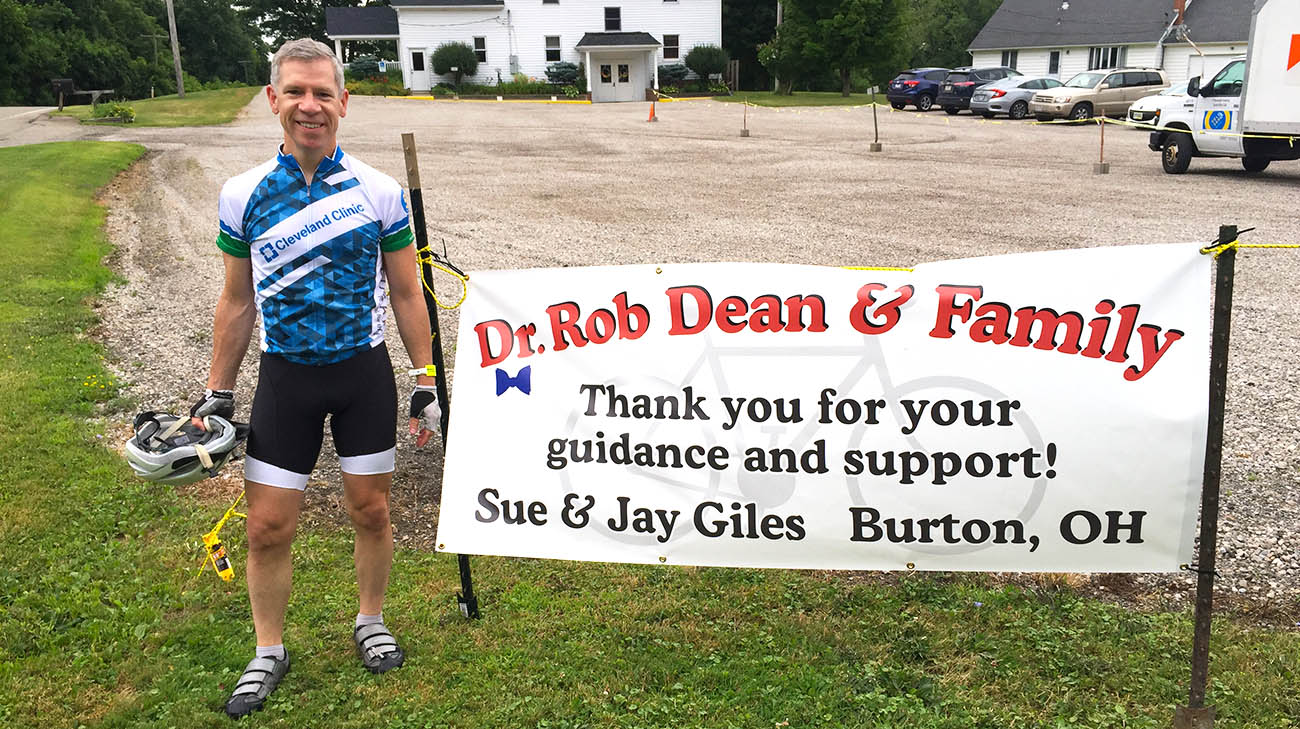 Dr. Robert Dean next to the sign patient Sue Giles and her husband created to display during Dr. Dean's VeloSano ride. 