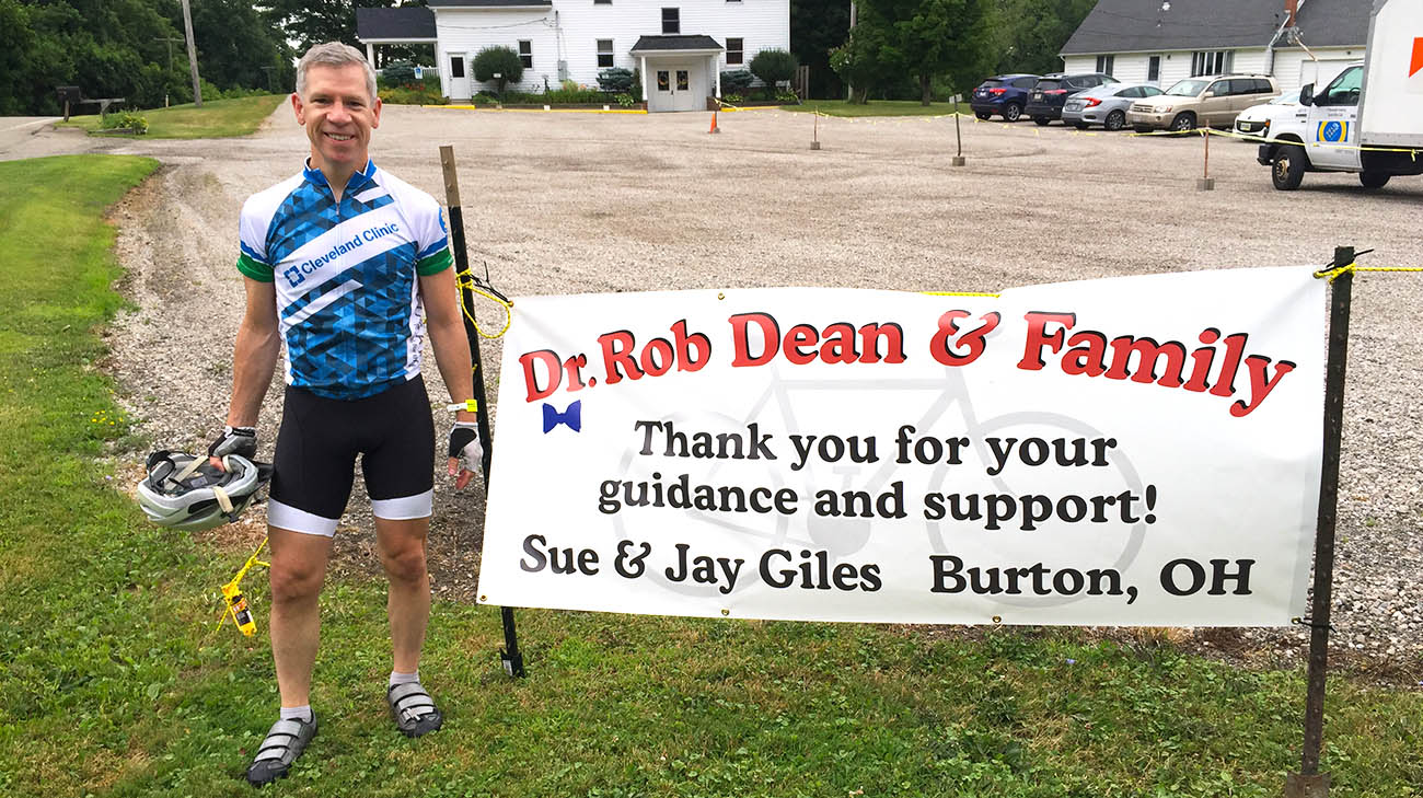 Dr. Robert Dean next to the sign patient Sue Giles and her husband created to display during Dr. Dean's VeloSano ride.