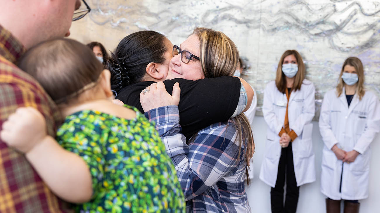 Organ donor Lori Seitz hugs the mother of transplant recipient, Emma Murphy. 
