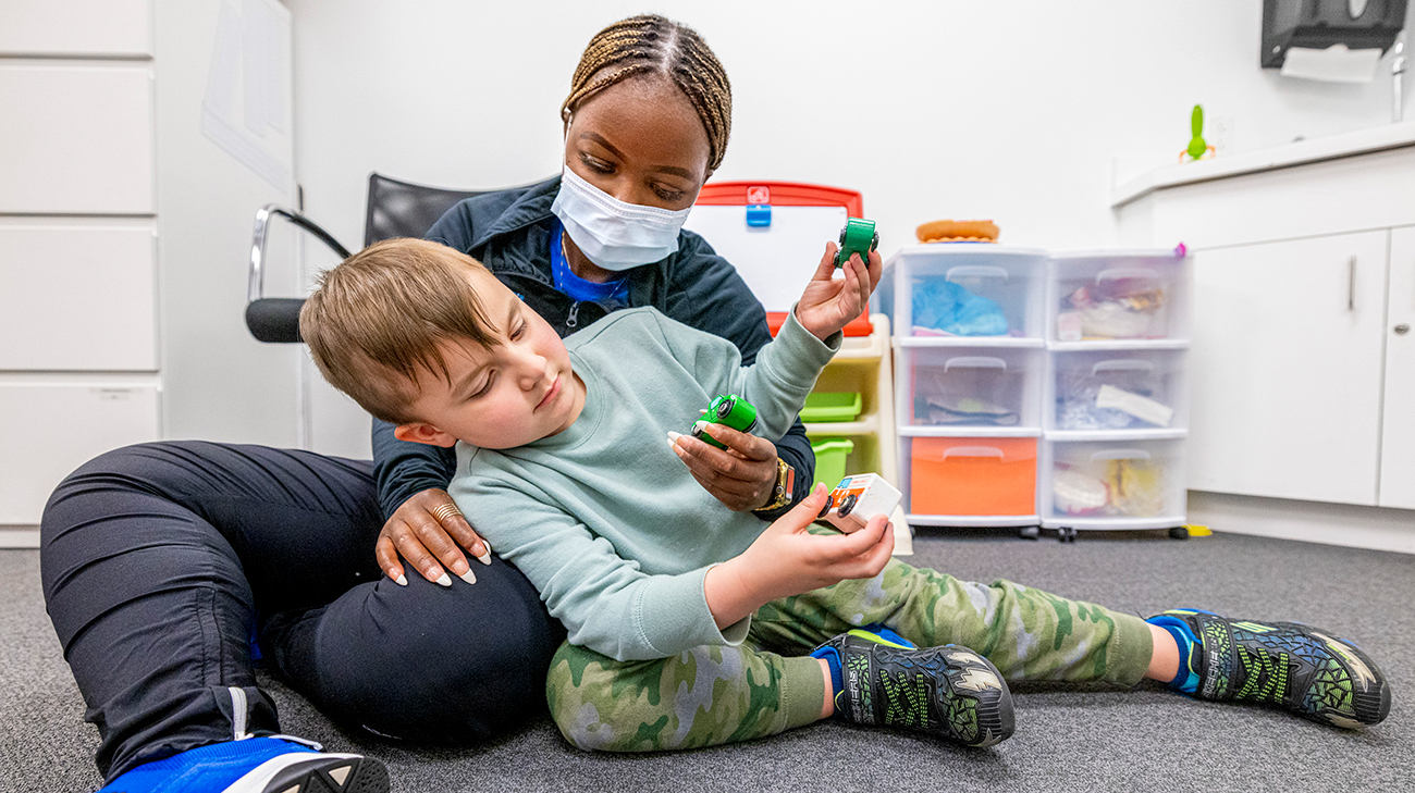 Johnny playing with Rumbi Mupinga, a registered behavior technician.