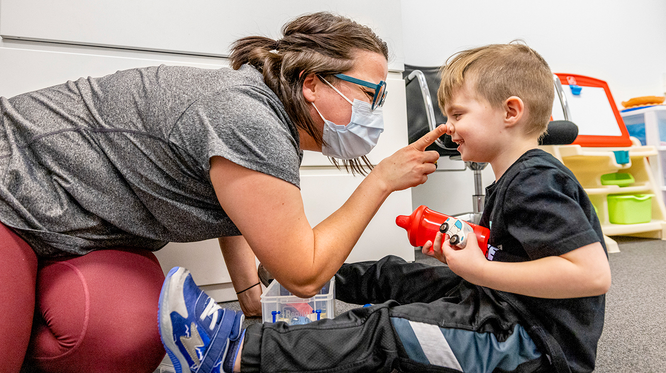 Jackie pokes Oliver's nose as she takes a break with him during therapy.