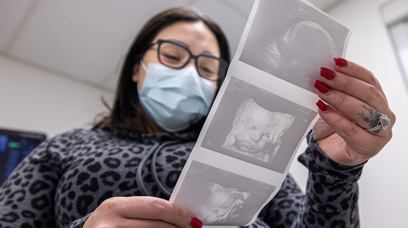 Jeanette looking at ultrasound image of her twins.