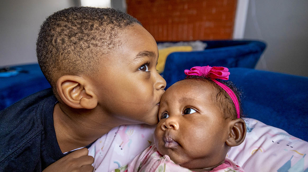 Breona's son kisses his sister.