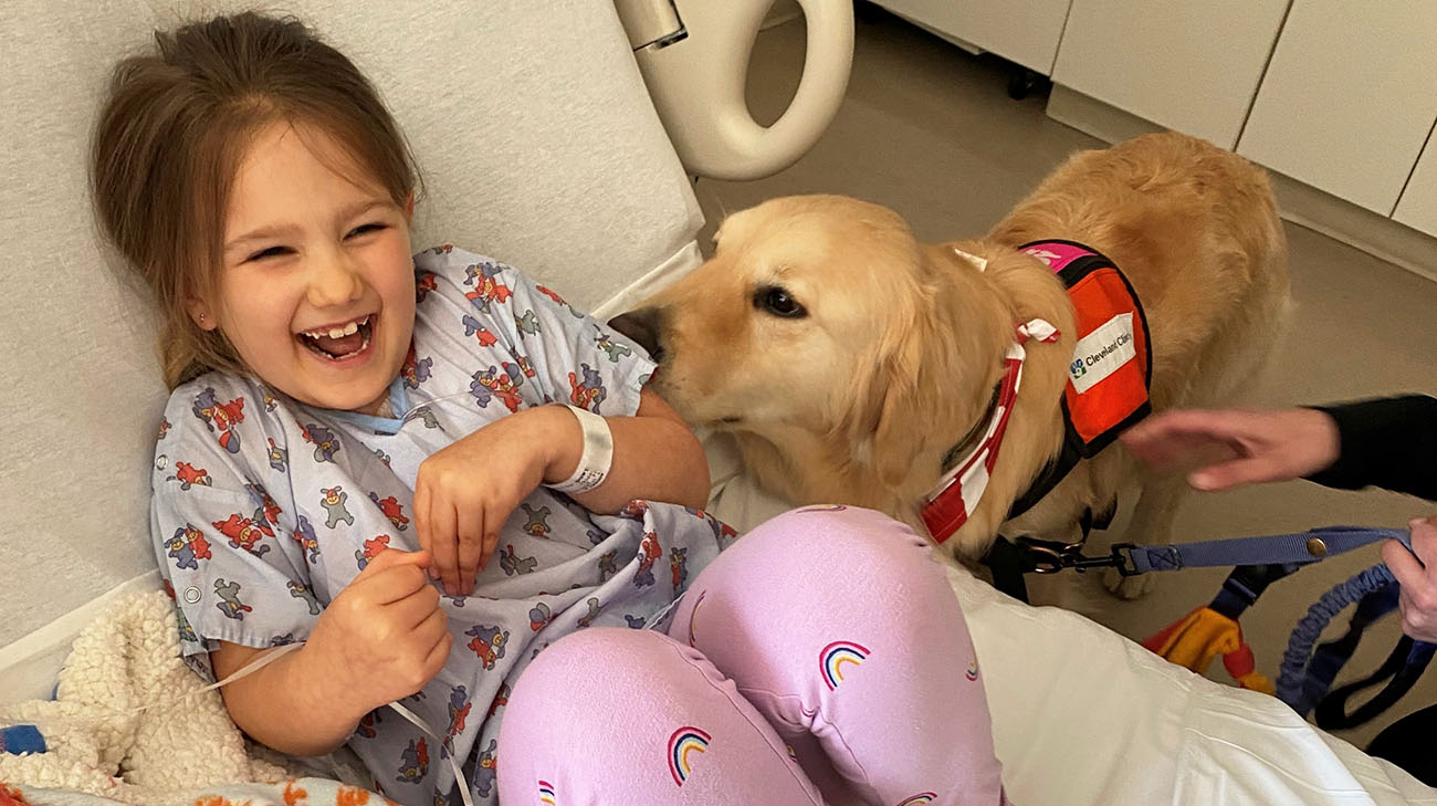 Audrey with facility dog Kid at Cleveland Clinic Children's. 