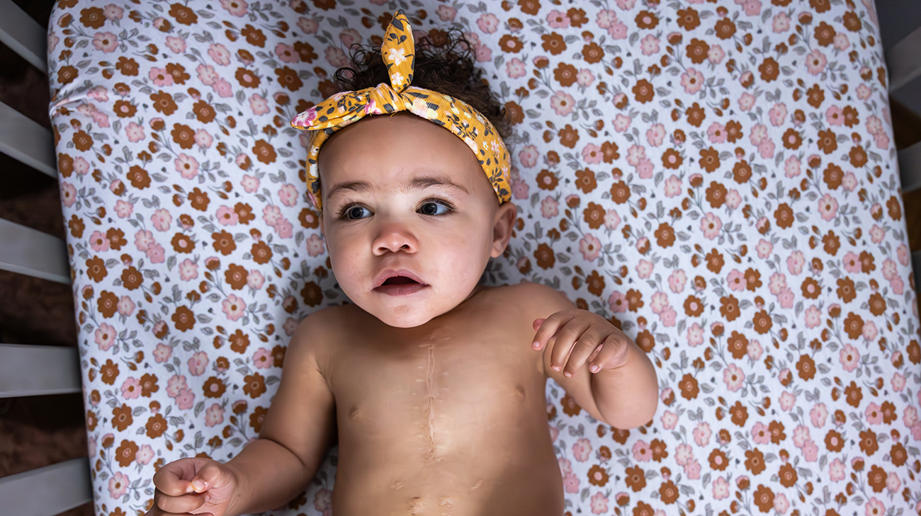 Adaya at home in crib.