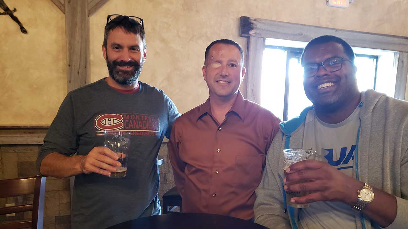 Dr. Lamarre (left) and Dr. Woodard (right) visit with John (center) at Paladin.