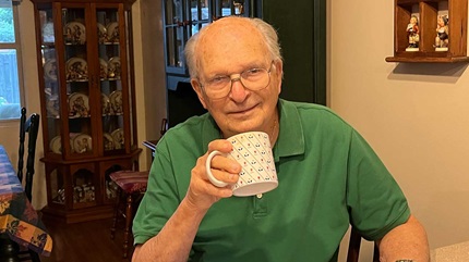 Phillip Schwenz holding his coffee mug without any tremors.