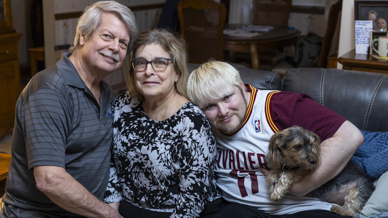 James with his dad, Jim, mom, Becky, and their dog. 