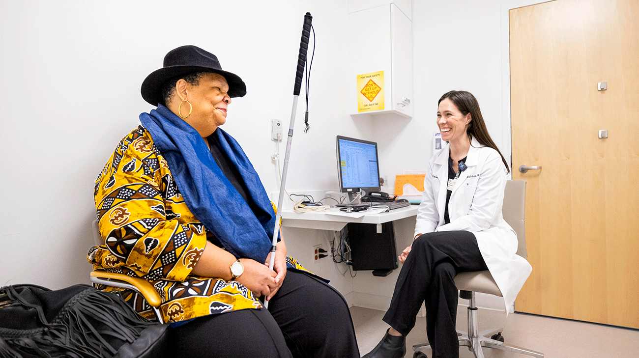 Patient, Willetta Tucker, sitting and talking with Cleveland Clinic doctor.