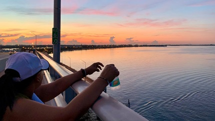 Patient, Marianela Betancourt, overlooking the ocean and sunset.