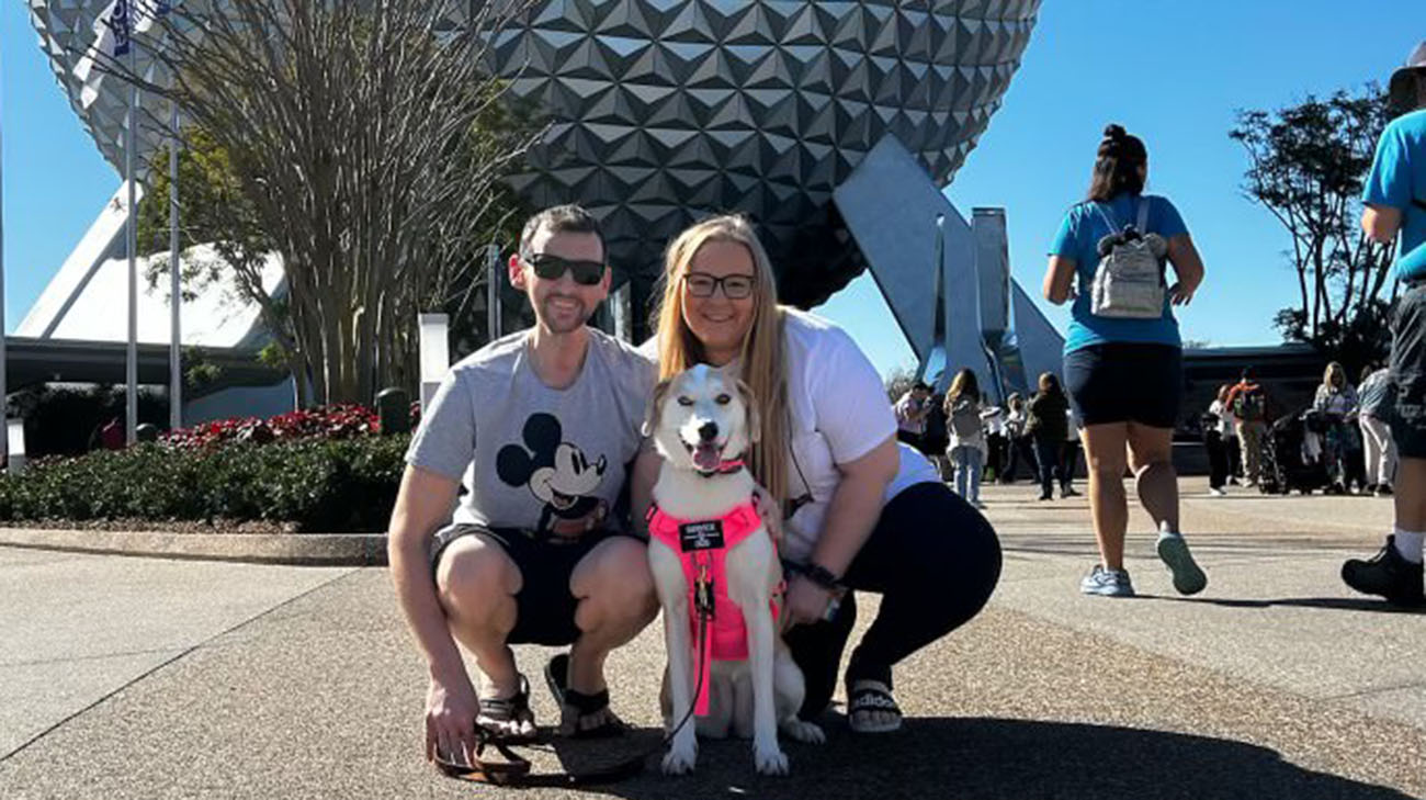 Aaron, Danielle and their dog at Disney. 