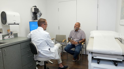 Patient, Edwin Oquendo, sits down to talk with Dr. Federico Serrot.