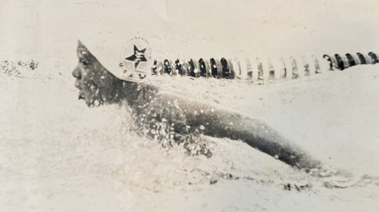 Black and white image of ten-year-old Stuart Patterson swimming in a pool.