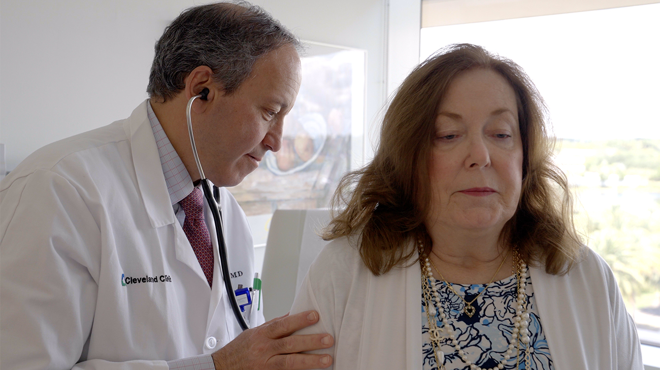 David Baran, MD checking Susan's heart rate