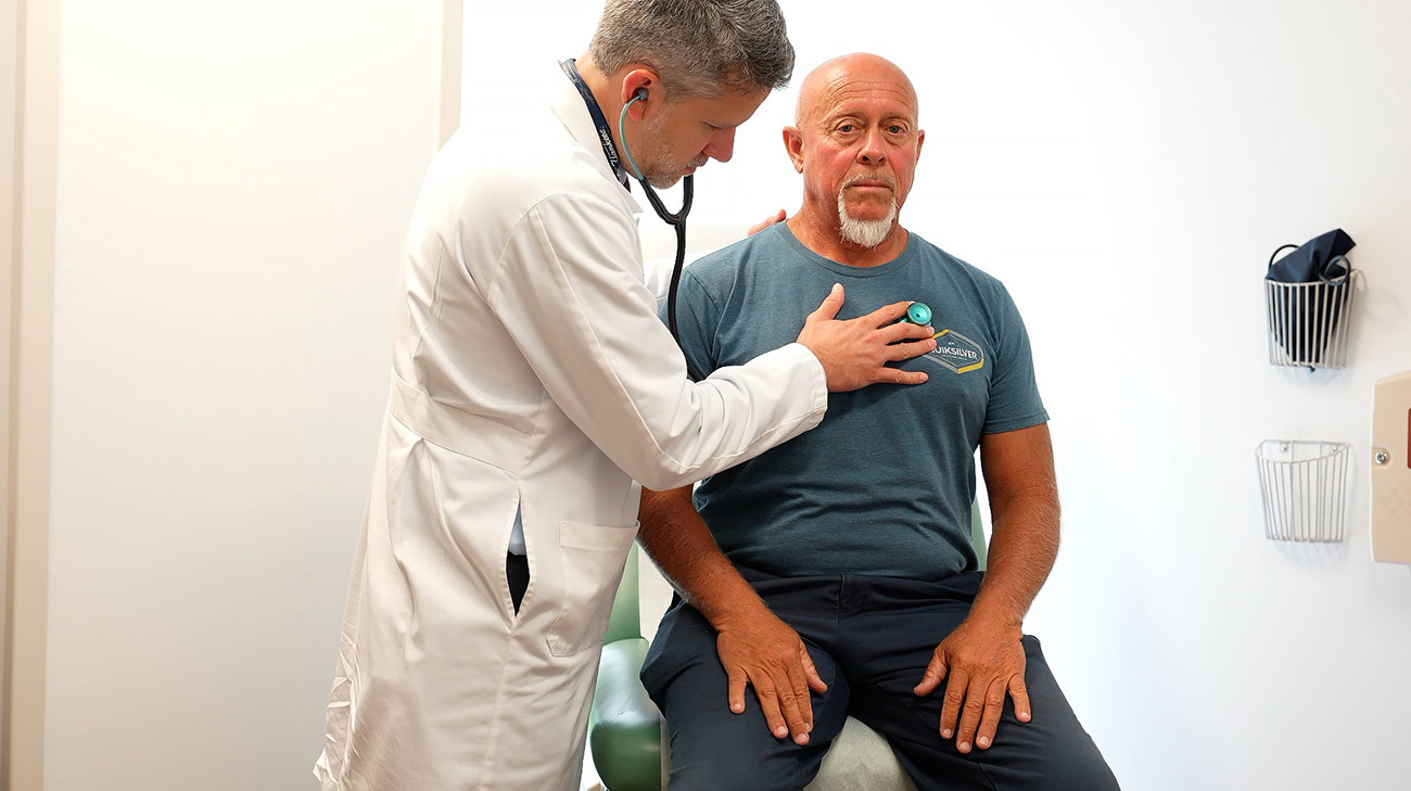 Cleveland Clinic physician checking Antoine Van Meir heart and lungs.