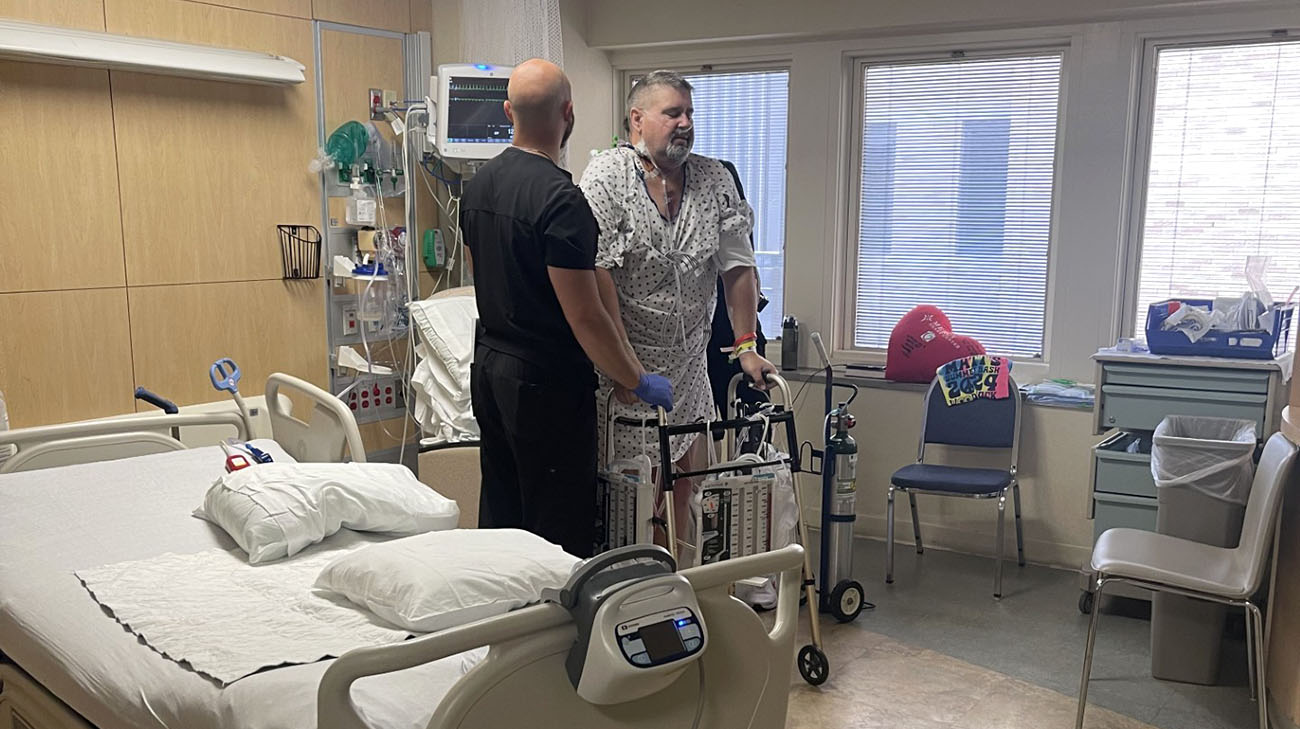 Ernie takes his first steps toward recovery after two days post-surgery with the help of his physical therapist, Jake Krupko.